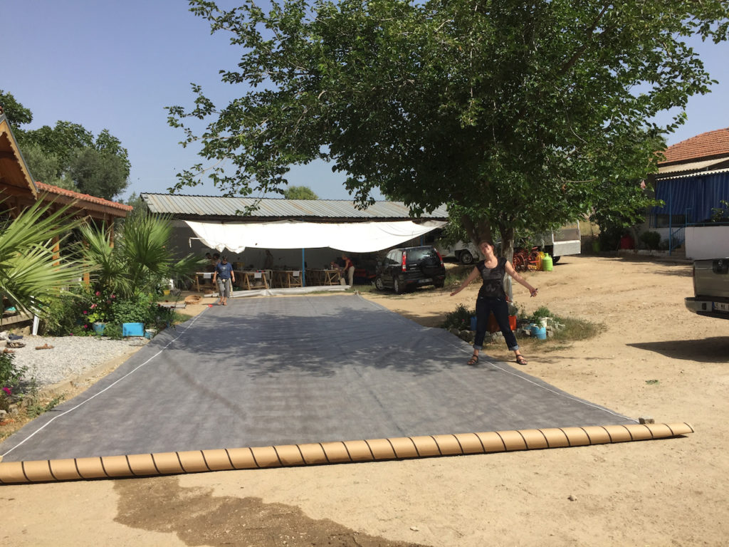 In anticipation of this process, the conservation team unrolled geotextile to cut more manageable pieces to use in the field. 